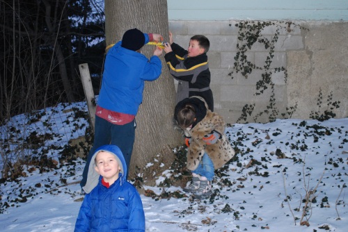 Steve and the kids measure the tree circumference to determine how many taps we need